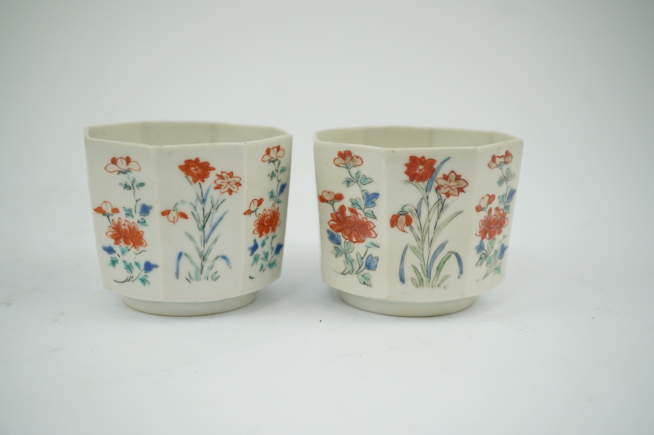 A pair of Japanese kakiemon octagonal porcelain cups, probably Edo period, 5.5cm high. Condition - one restored the other hairline cracks